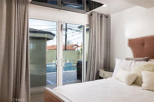 bedroom featuring hardwood / wood-style floors and access to exterior