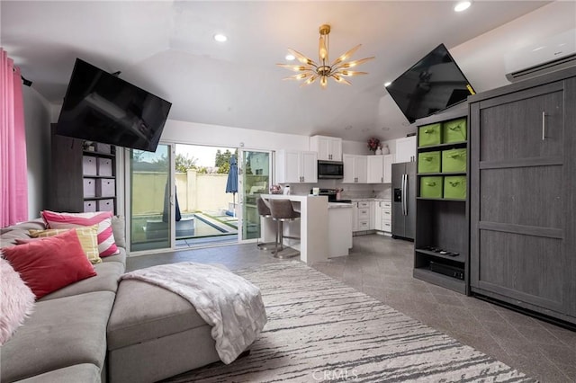 living room with lofted ceiling, a wall unit AC, and a notable chandelier