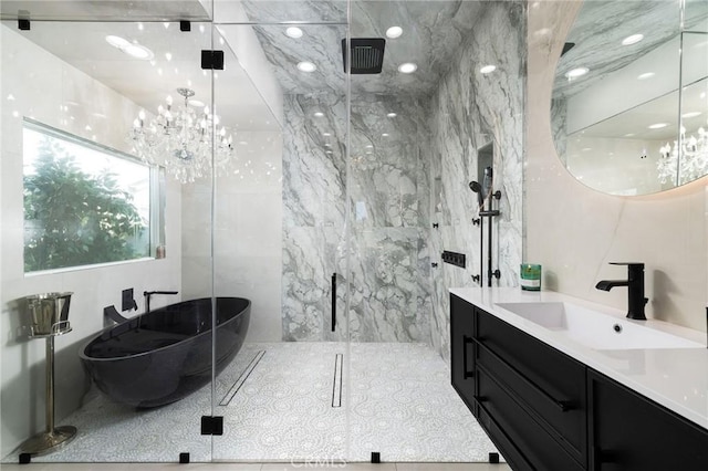 bathroom with plus walk in shower, tile walls, vanity, and an inviting chandelier