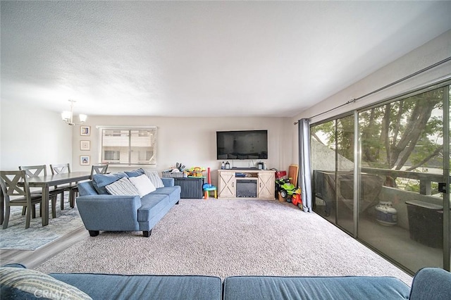 living room featuring a textured ceiling and a chandelier