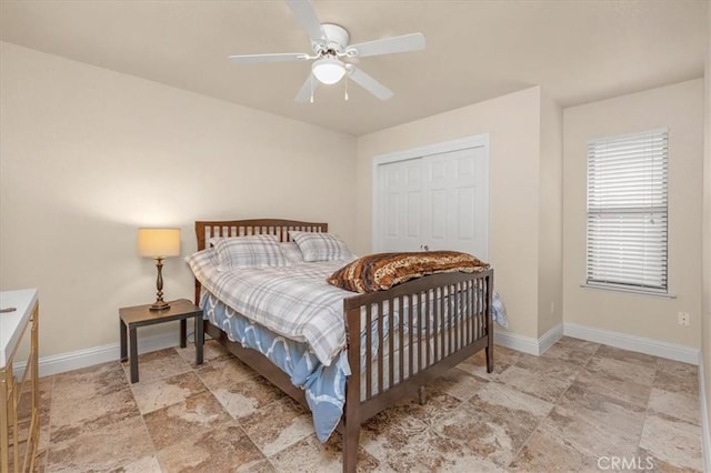 bedroom featuring ceiling fan and a closet