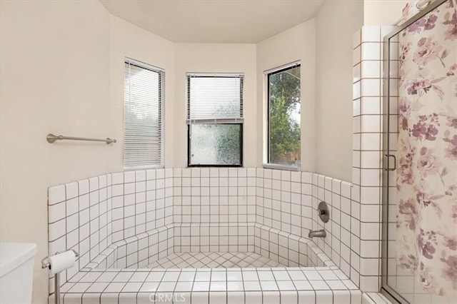 bathroom with an enclosed shower and toilet