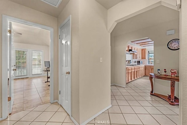 hall featuring light tile patterned floors