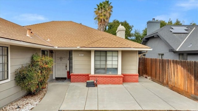 view of exterior entry with a patio area