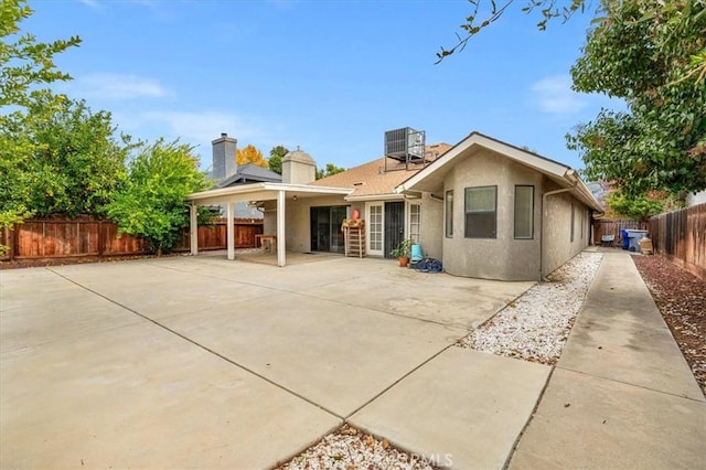 rear view of house with a patio and central air condition unit