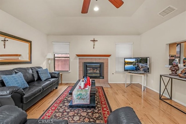 living room with ceiling fan and light hardwood / wood-style flooring