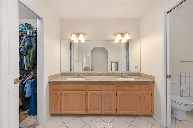 bathroom featuring tile patterned flooring, vanity, and toilet