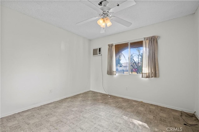 carpeted empty room with ceiling fan, a wall mounted air conditioner, and a textured ceiling