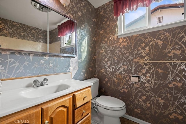 bathroom featuring vanity and toilet