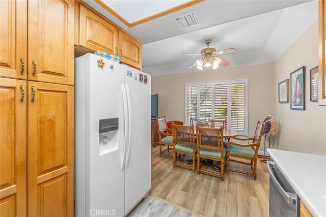 kitchen featuring dishwasher, ceiling fan, white refrigerator with ice dispenser, and light hardwood / wood-style flooring