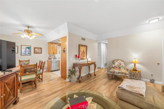 living room with ceiling fan and light hardwood / wood-style floors