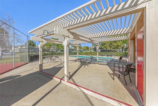 view of patio with a fenced in pool and a pergola