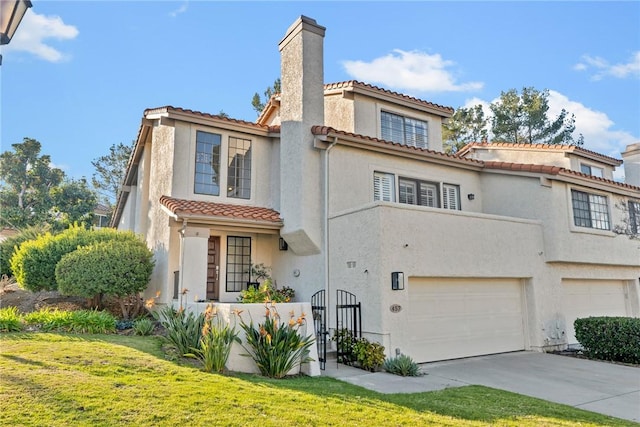 mediterranean / spanish-style home featuring stucco siding, driveway, a garage, a chimney, and a tiled roof