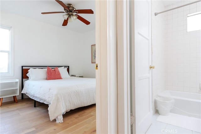 bedroom with ceiling fan and light hardwood / wood-style flooring