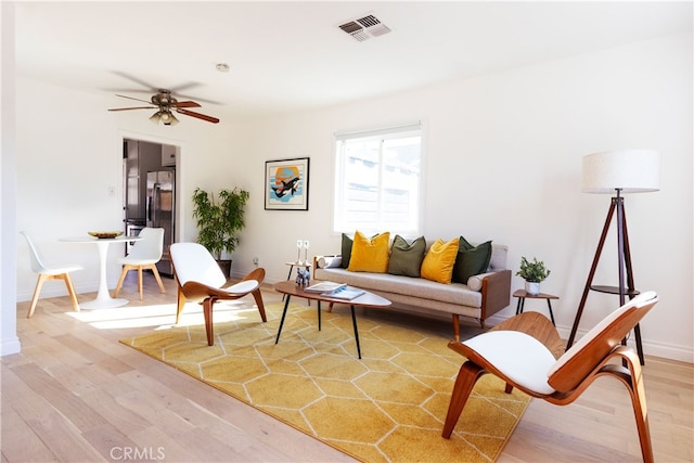 living room with hardwood / wood-style floors and ceiling fan