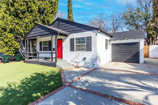 view of front of house with a porch, a garage, and a front lawn