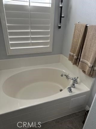 bathroom featuring a bath and tile patterned floors