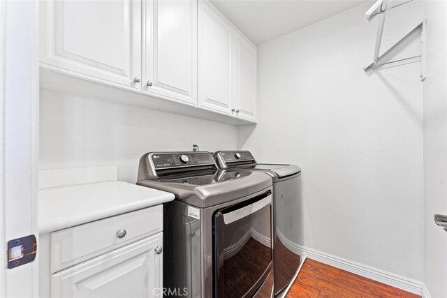 22 Arlington St, Ladera Ranch, CA 92694 - laundry area with separate washer and dryer, cabinet space, baseboards, and wood finished floors