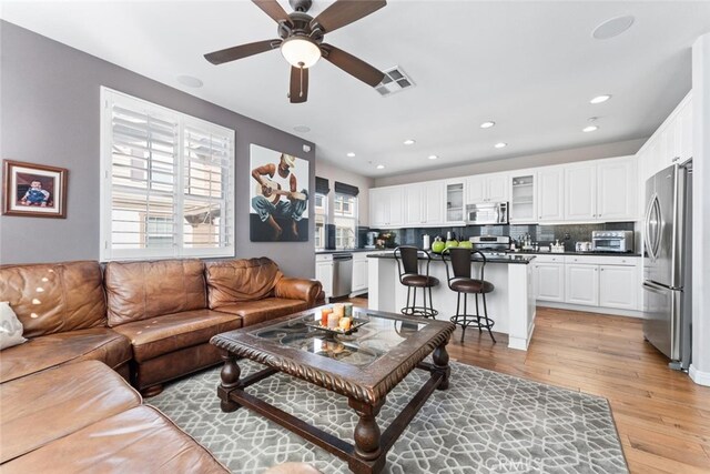 22 Arlington St, Ladera Ranch, CA 92694 - living area featuring light wood-style floors, ceiling fan, plenty of natural light, and recessed lighting