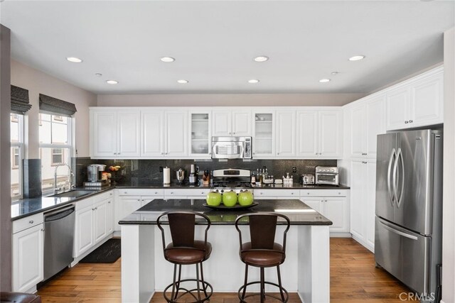 22 Arlington St, Ladera Ranch, CA 92694 - kitchen featuring appliances with stainless steel finishes, a sink, dark countertops, backsplash, and recessed lighting