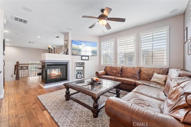 living area featuring a ceiling fan, visible vents, recessed lighting, and light wood-type flooring