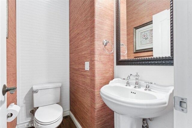 half bath with a sink and toilet