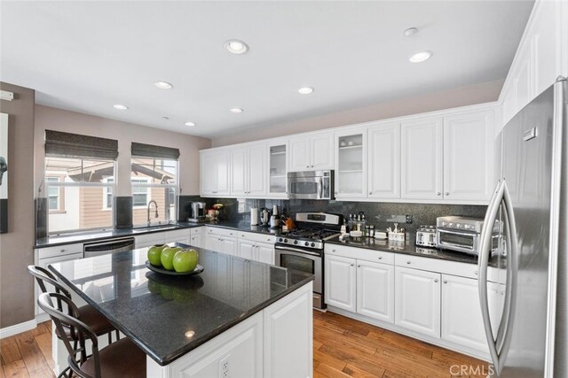 22 Arlington St, Ladera Ranch, CA 92694 - kitchen with appliances with stainless steel finishes, a sink, backsplash, white cabinets, and recessed lighting