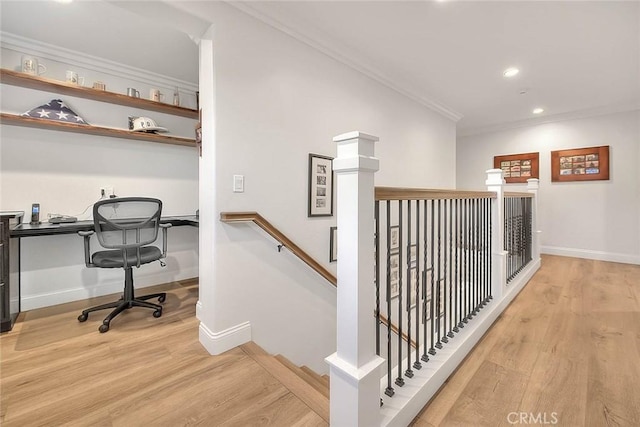 interior space featuring hardwood / wood-style flooring, crown molding, and built in desk