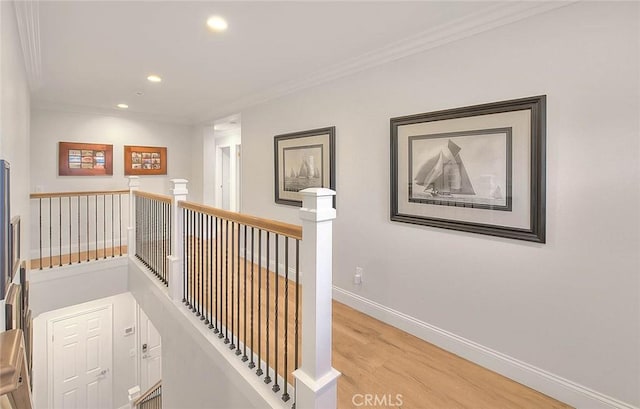 hall featuring ornamental molding and light wood-type flooring