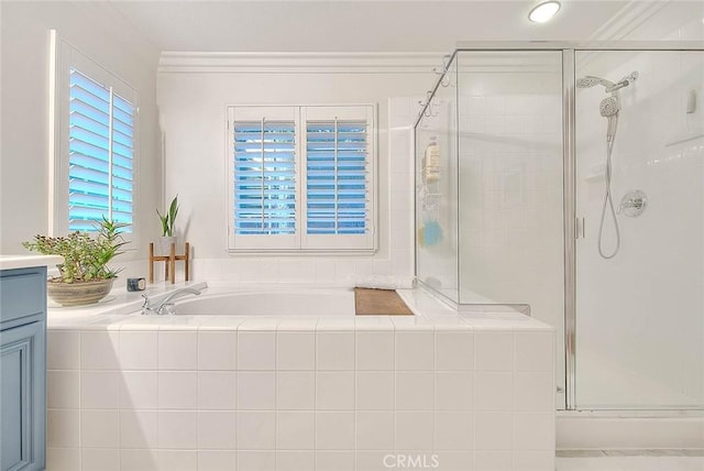 bathroom with ornamental molding, vanity, and shower with separate bathtub