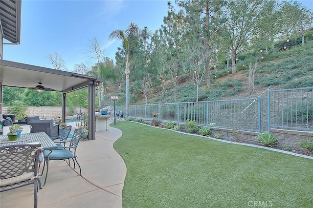 view of yard with an outdoor hangout area, ceiling fan, and a patio area