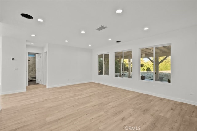 spare room with baseboards, light wood-style flooring, visible vents, and recessed lighting