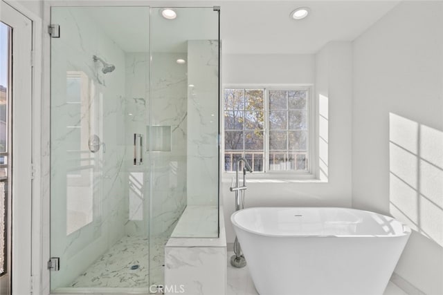 bathroom featuring marble finish floor, a soaking tub, a marble finish shower, and recessed lighting