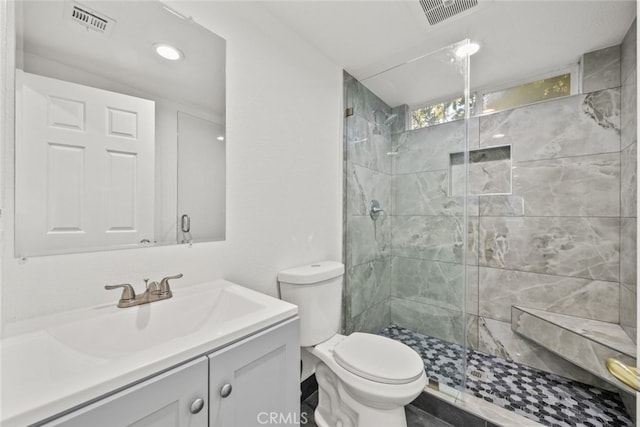 full bathroom with toilet, a shower stall, and visible vents