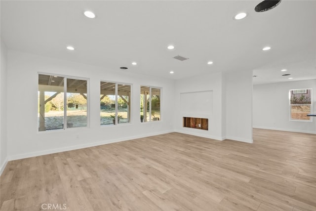 unfurnished living room with light hardwood / wood-style floors