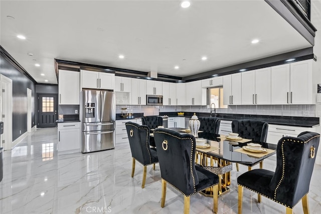 dining room with ornamental molding, a healthy amount of sunlight, and sink