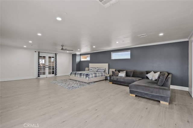 living room featuring crown molding, french doors, ceiling fan, and light wood-type flooring