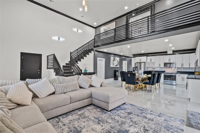 living room with crown molding and a high ceiling