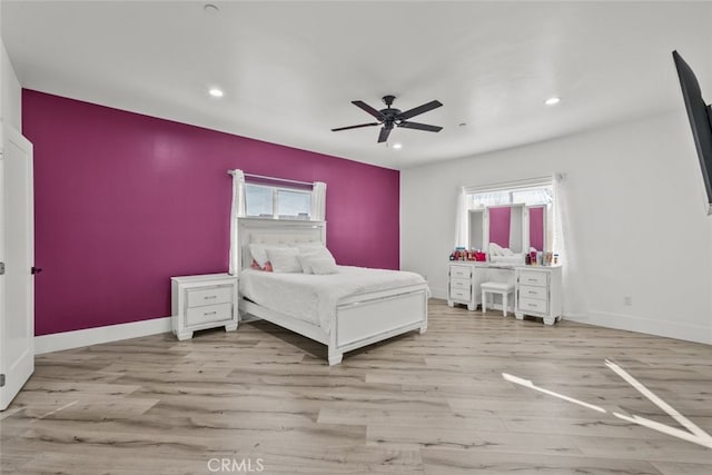 bedroom with ceiling fan and light wood-type flooring