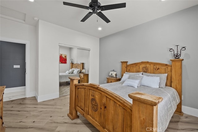 bedroom with light hardwood / wood-style flooring, a closet, and ceiling fan