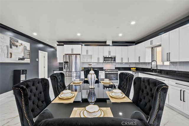 dining space featuring crown molding and sink