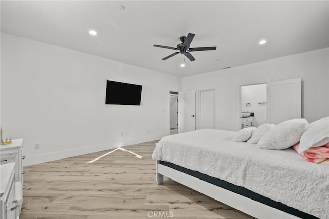 bedroom with light hardwood / wood-style floors and ceiling fan