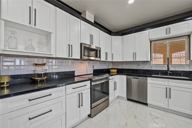 kitchen featuring appliances with stainless steel finishes, sink, and white cabinets