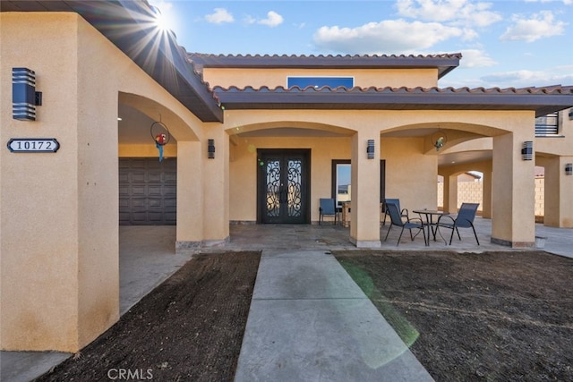 doorway to property featuring a patio area and french doors