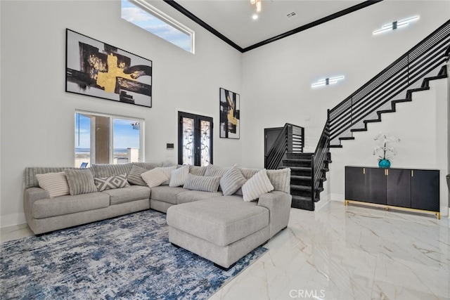 living room with crown molding, french doors, and a high ceiling