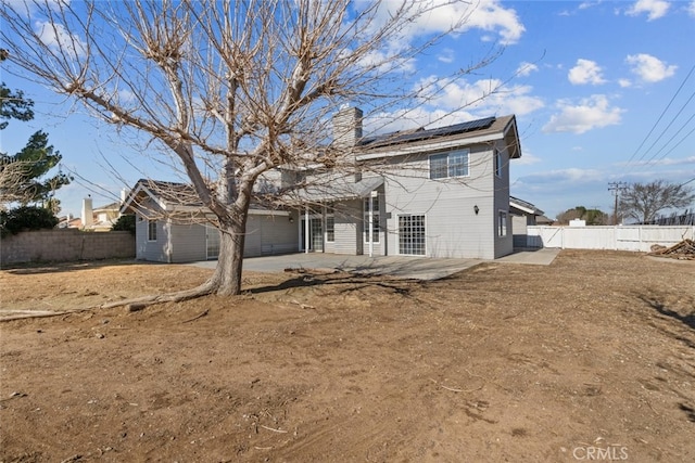 rear view of house with solar panels