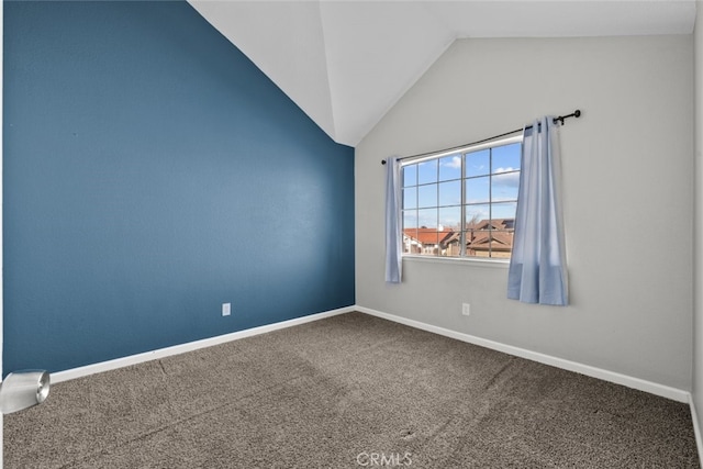 carpeted empty room featuring lofted ceiling