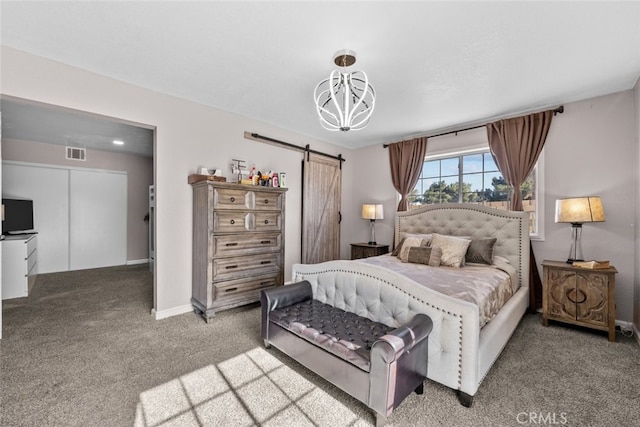 carpeted bedroom with a barn door and an inviting chandelier