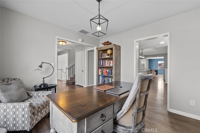 home office with dark hardwood / wood-style flooring