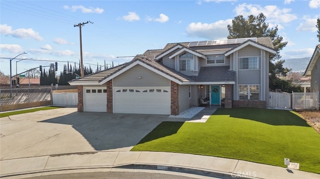 front facade featuring a garage, a front yard, and solar panels